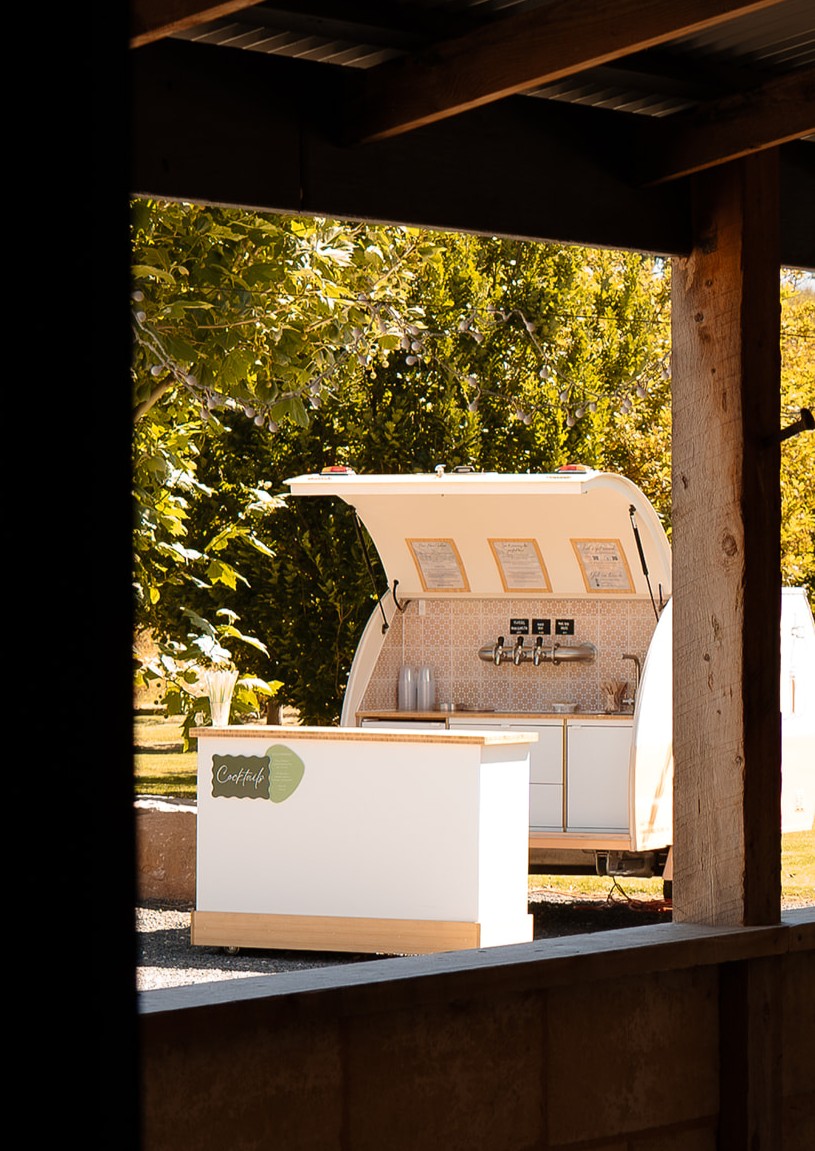 The Park 'n' Pour service table with matching timber benchtop parked beside the Teardrop Bar at an outdoor event