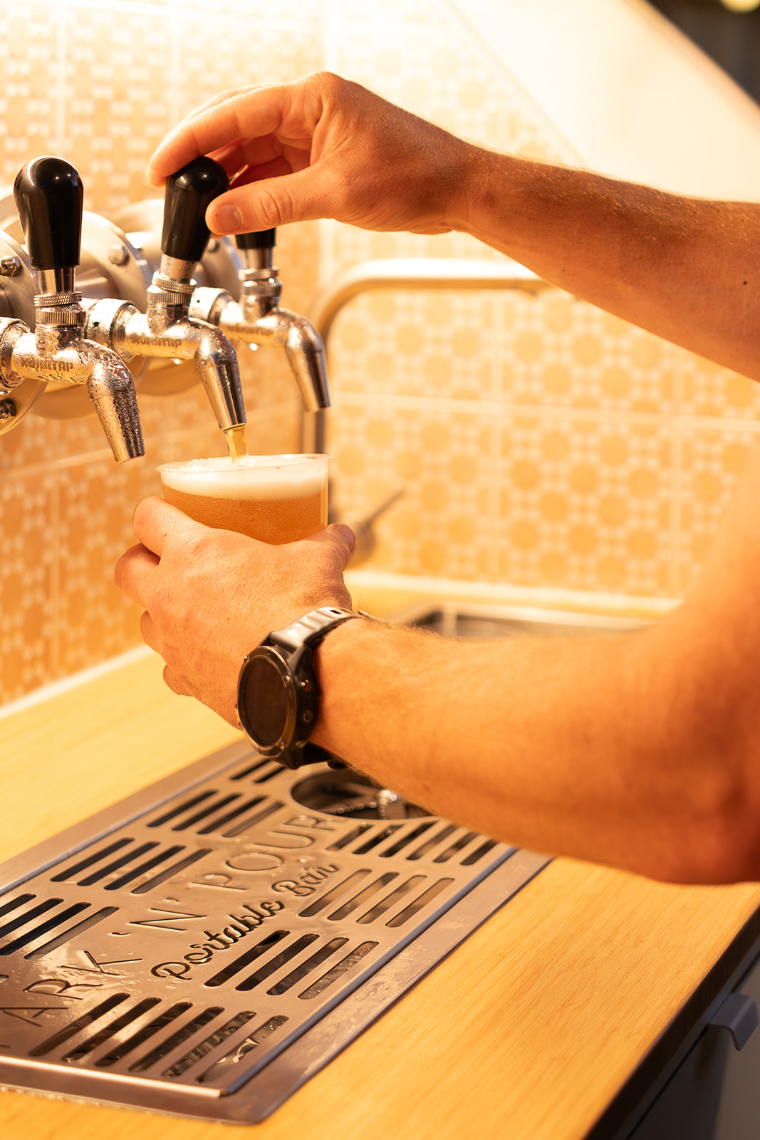 Beer being poured from the Park 'n' Pour taps into a cup